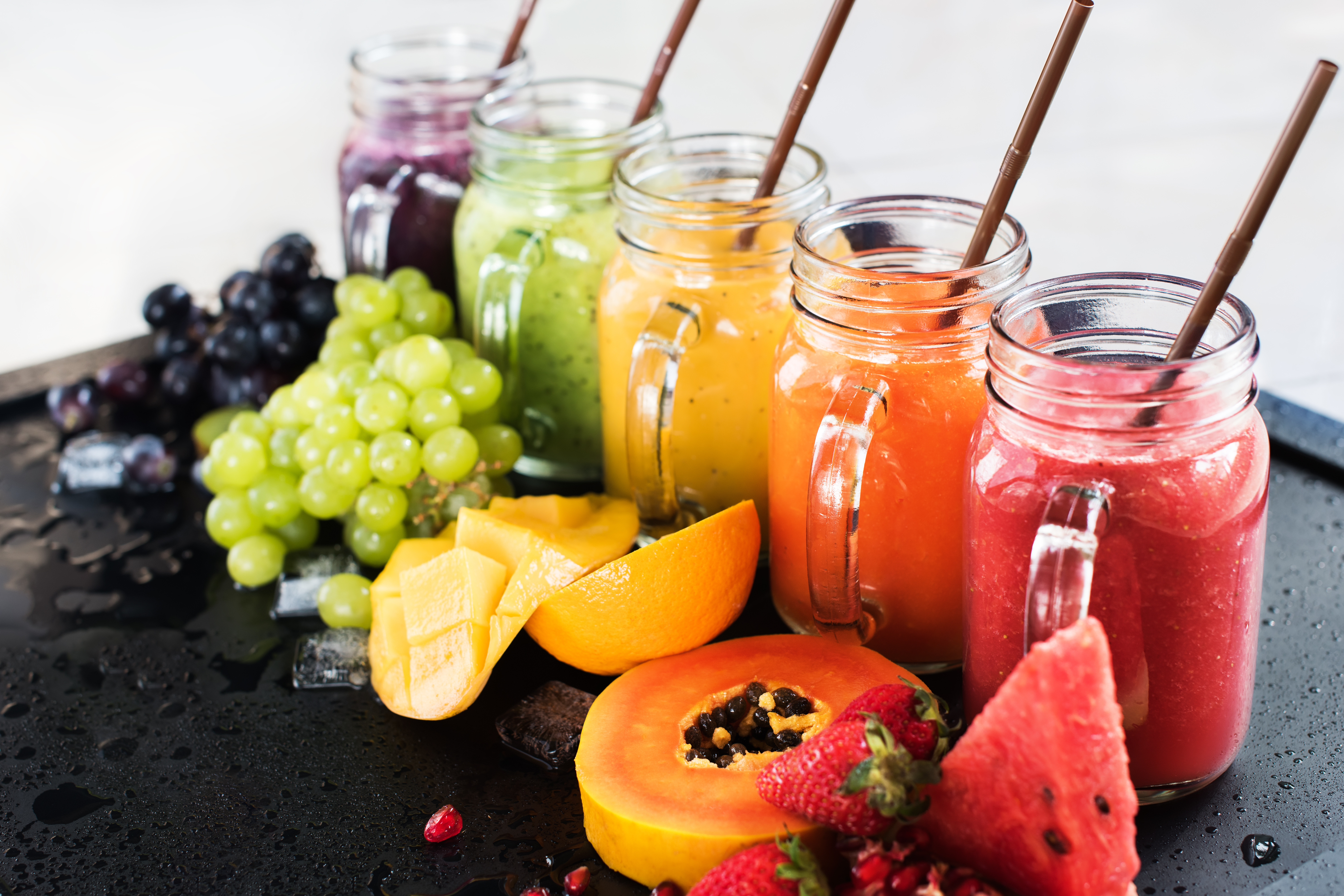 Fresh fruit and fresh squeezed juice in glass mugs